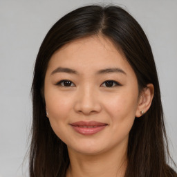 Joyful asian young-adult female with long  brown hair and brown eyes