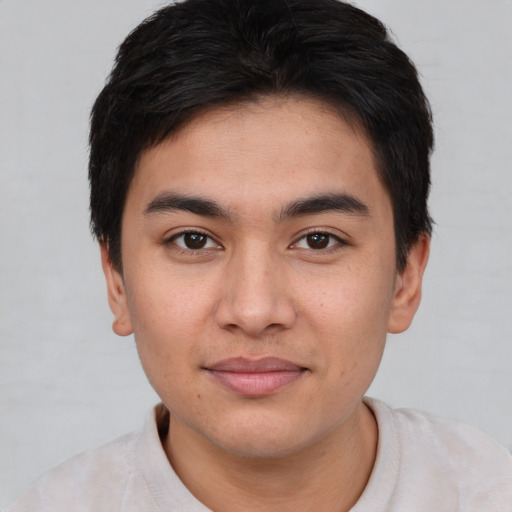 Joyful asian young-adult male with short  brown hair and brown eyes