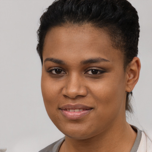 Joyful black young-adult female with short  brown hair and brown eyes