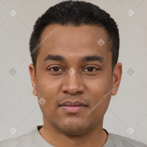 Joyful latino young-adult male with short  black hair and brown eyes