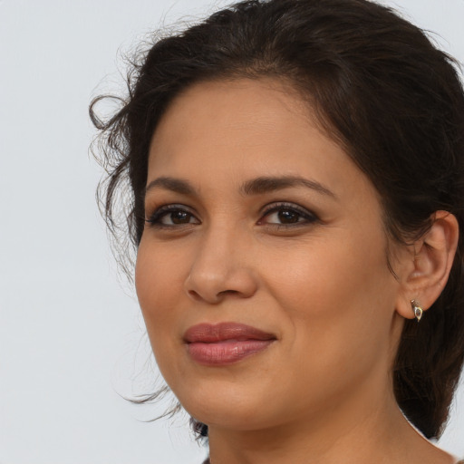 Joyful latino young-adult female with medium  brown hair and brown eyes