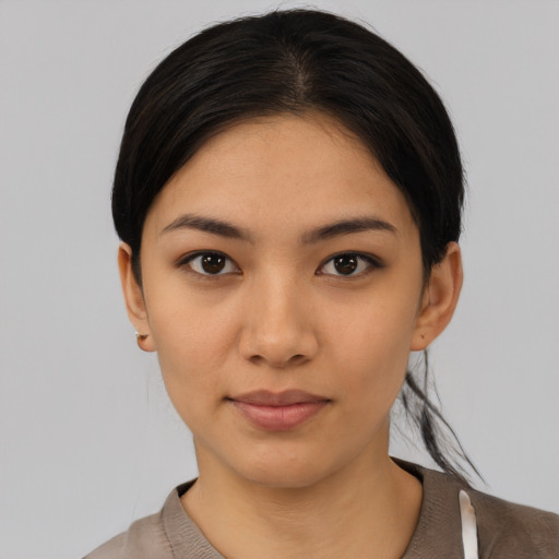 Joyful asian young-adult female with medium  black hair and brown eyes