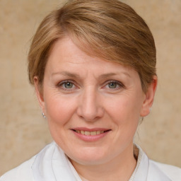 Joyful white adult female with medium  brown hair and blue eyes