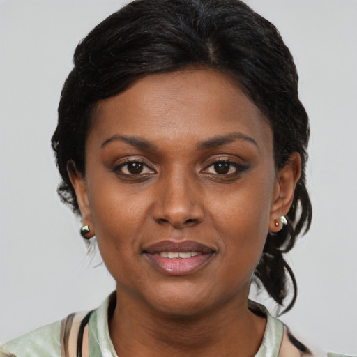 Joyful black young-adult female with medium  brown hair and brown eyes