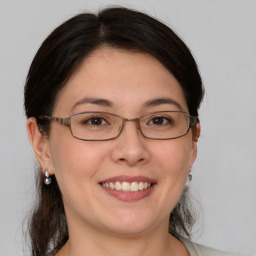 Joyful white young-adult female with medium  brown hair and brown eyes