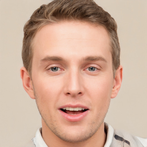 Joyful white young-adult male with short  brown hair and grey eyes