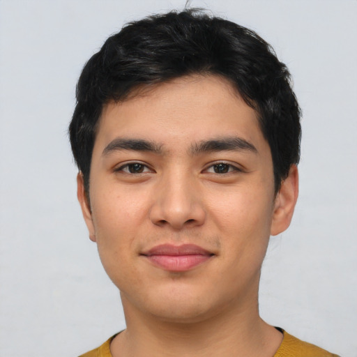 Joyful asian young-adult male with short  black hair and brown eyes