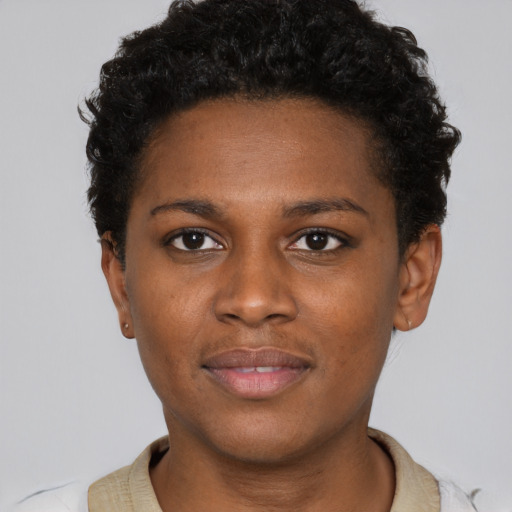 Joyful black young-adult female with short  black hair and brown eyes