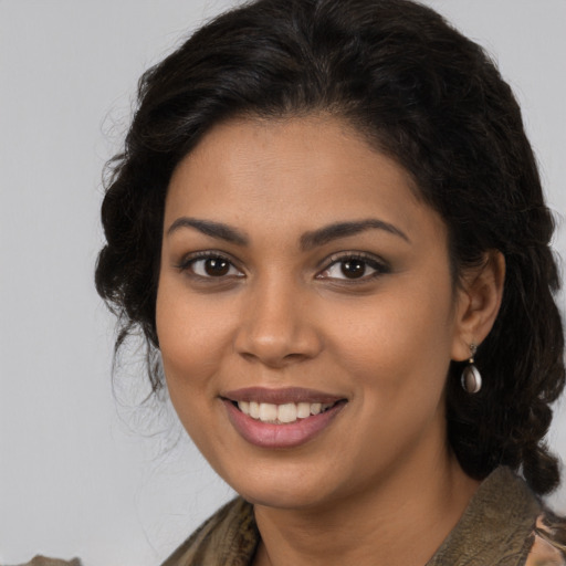 Joyful latino young-adult female with medium  brown hair and brown eyes