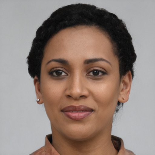 Joyful latino young-adult female with short  black hair and brown eyes