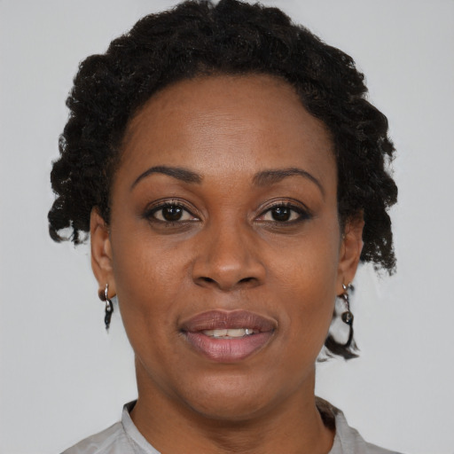 Joyful black adult female with short  brown hair and brown eyes