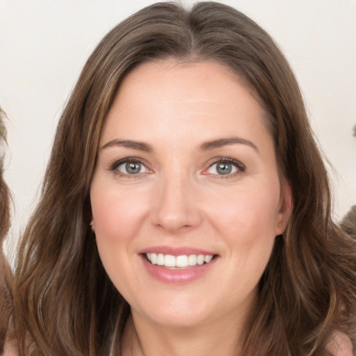 Joyful white young-adult female with long  brown hair and green eyes