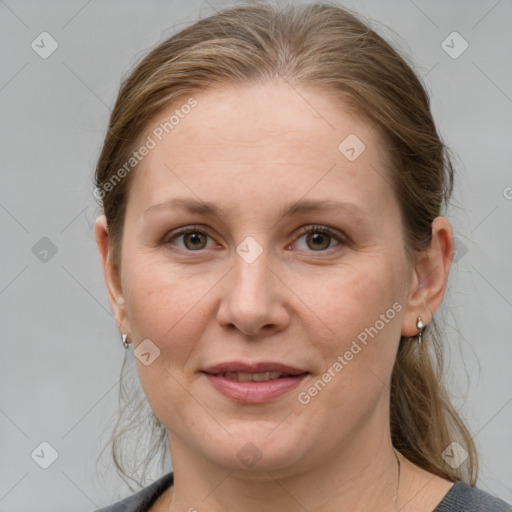 Joyful white adult female with medium  brown hair and grey eyes