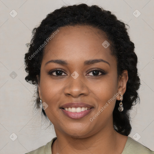 Joyful black young-adult female with long  black hair and brown eyes