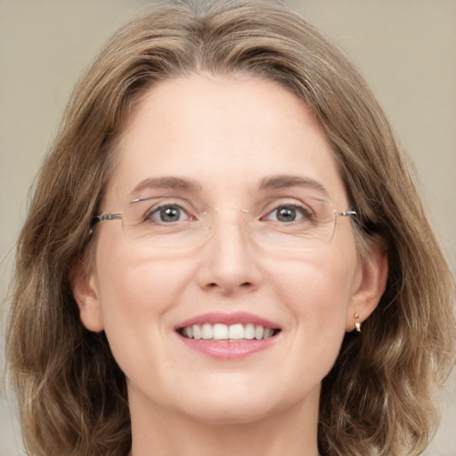 Joyful white adult female with medium  brown hair and green eyes