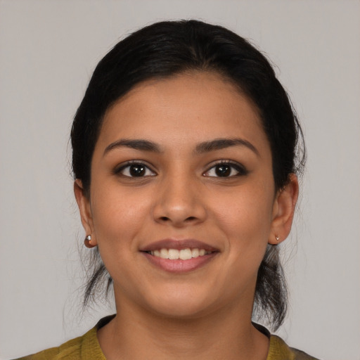 Joyful latino young-adult female with medium  black hair and brown eyes