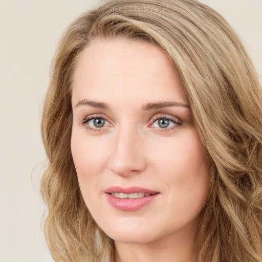 Joyful white young-adult female with long  brown hair and green eyes