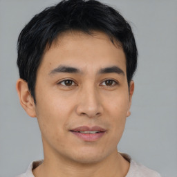 Joyful asian young-adult male with short  brown hair and brown eyes