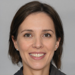 Joyful white adult female with medium  brown hair and brown eyes