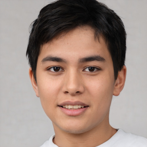 Joyful asian young-adult male with short  brown hair and brown eyes