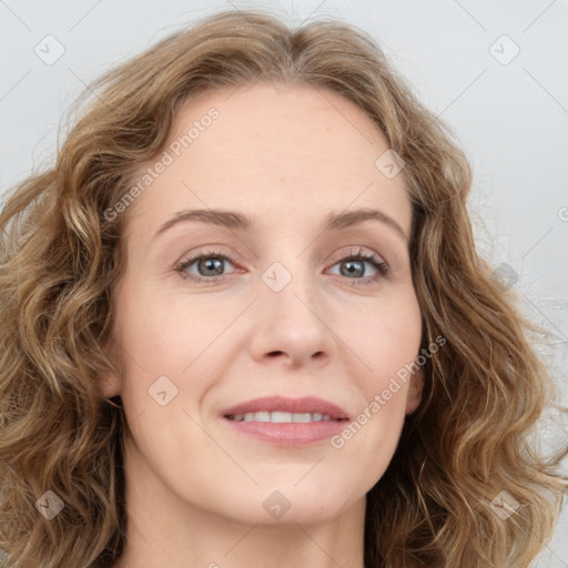 Joyful white young-adult female with long  brown hair and green eyes