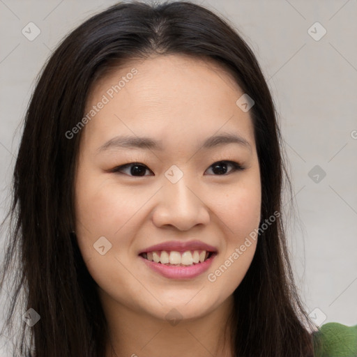 Joyful asian young-adult female with long  brown hair and brown eyes