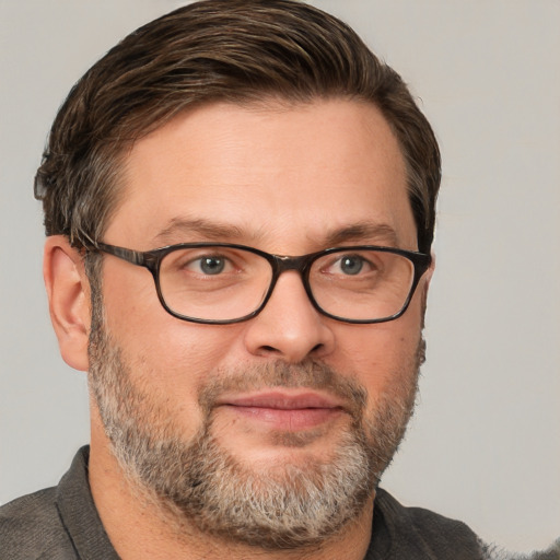 Joyful white adult male with short  brown hair and grey eyes