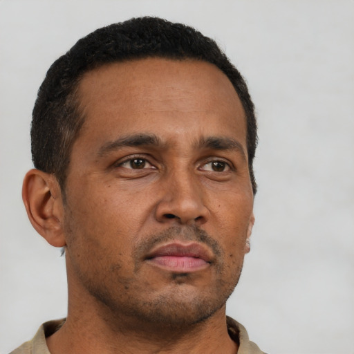 Neutral latino adult male with short  brown hair and brown eyes