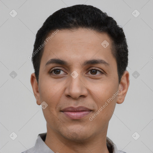 Joyful latino young-adult male with short  black hair and brown eyes