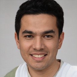 Joyful white young-adult male with short  black hair and brown eyes