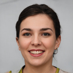 Joyful white young-adult female with medium  brown hair and brown eyes