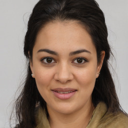 Joyful latino young-adult female with long  brown hair and brown eyes