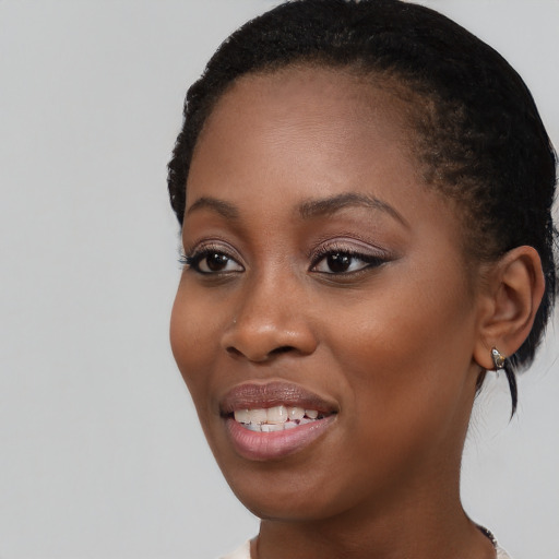 Joyful black young-adult female with medium  brown hair and brown eyes