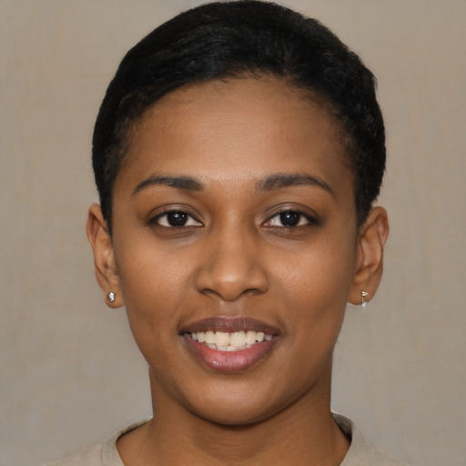 Joyful latino young-adult female with short  black hair and brown eyes