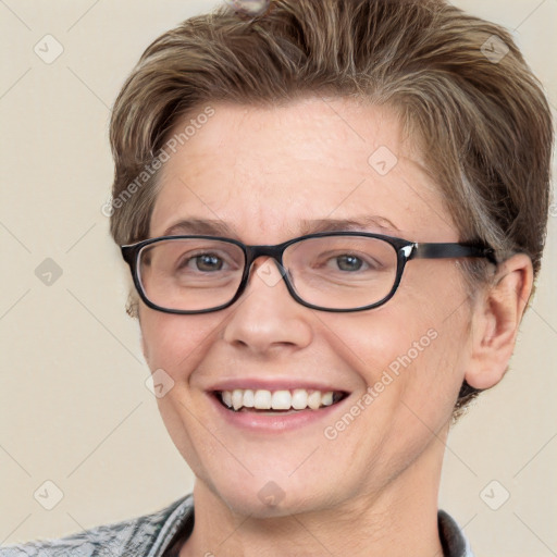 Joyful white adult female with short  brown hair and blue eyes