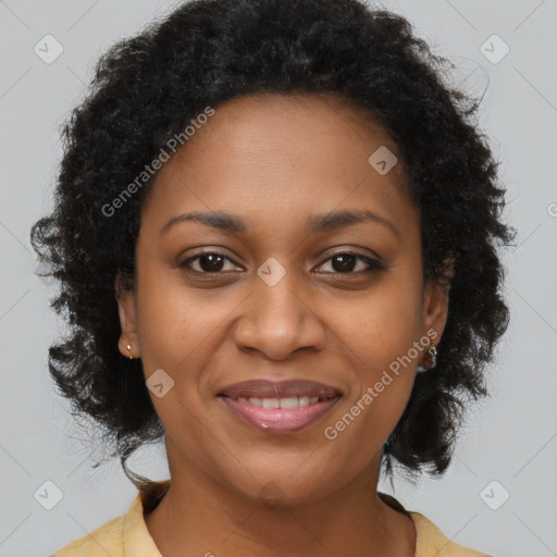 Joyful black adult female with medium  brown hair and brown eyes