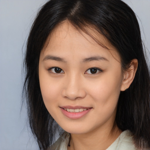 Joyful asian young-adult female with long  brown hair and brown eyes