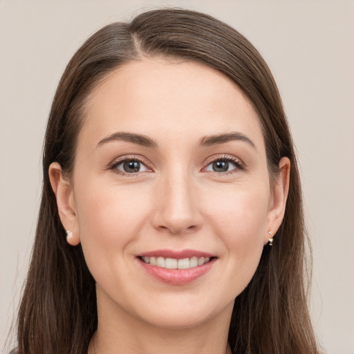 Joyful white young-adult female with long  brown hair and grey eyes