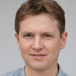 Joyful white adult male with short  brown hair and grey eyes