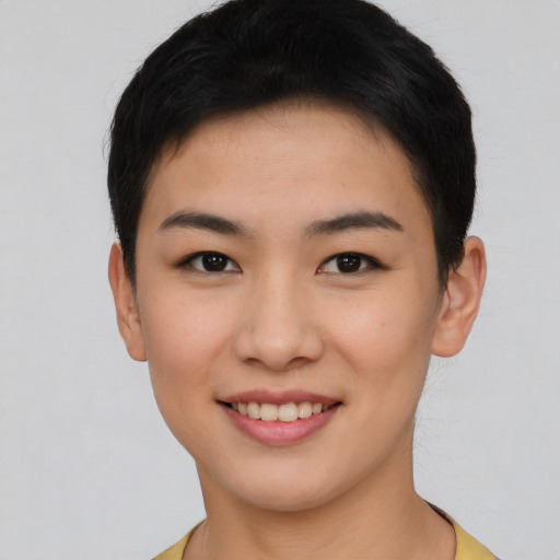 Joyful asian young-adult female with short  brown hair and brown eyes