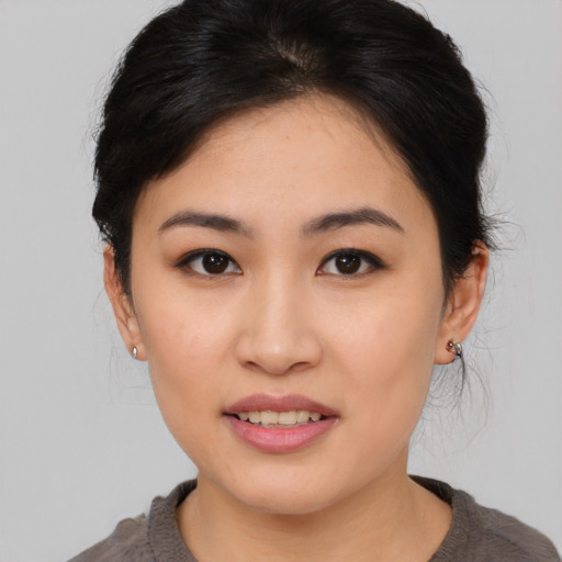 Joyful asian young-adult female with medium  brown hair and brown eyes