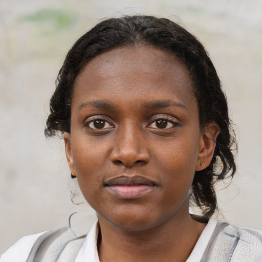 Neutral black young-adult female with medium  brown hair and brown eyes
