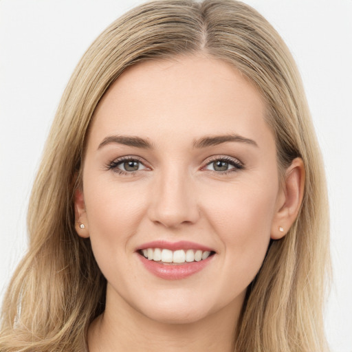 Joyful white young-adult female with long  brown hair and green eyes