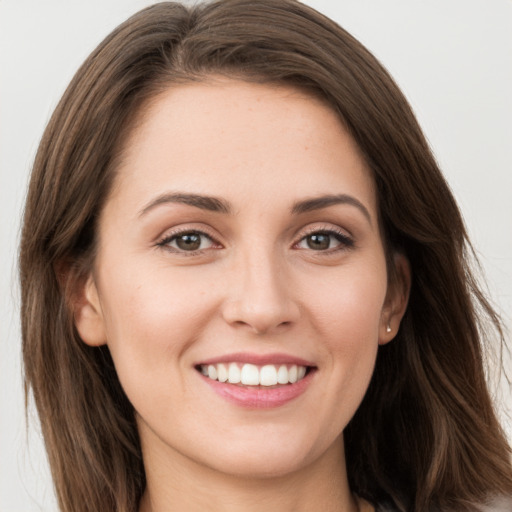 Joyful white young-adult female with long  brown hair and grey eyes