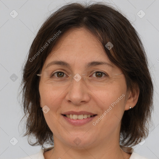 Joyful white adult female with medium  brown hair and brown eyes