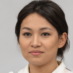 Joyful asian young-adult female with medium  brown hair and brown eyes