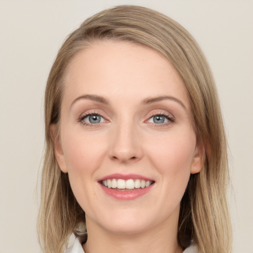 Joyful white young-adult female with medium  brown hair and green eyes