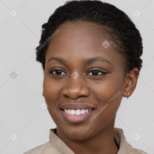 Joyful black young-adult female with short  black hair and brown eyes