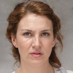 Joyful white adult female with medium  brown hair and grey eyes