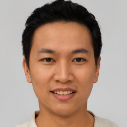 Joyful asian young-adult male with short  black hair and brown eyes